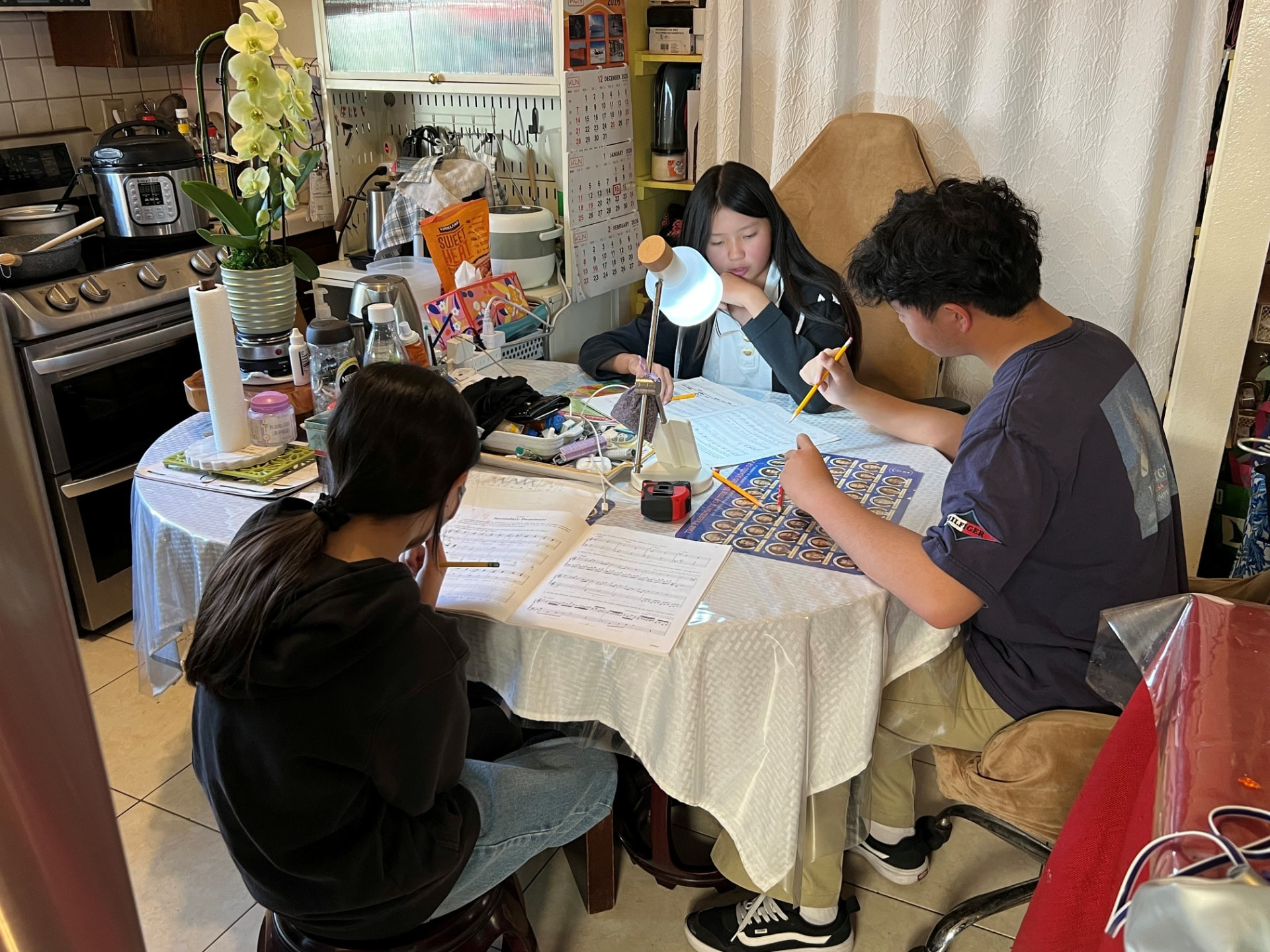 Brendan Li working through theory worksheets with students